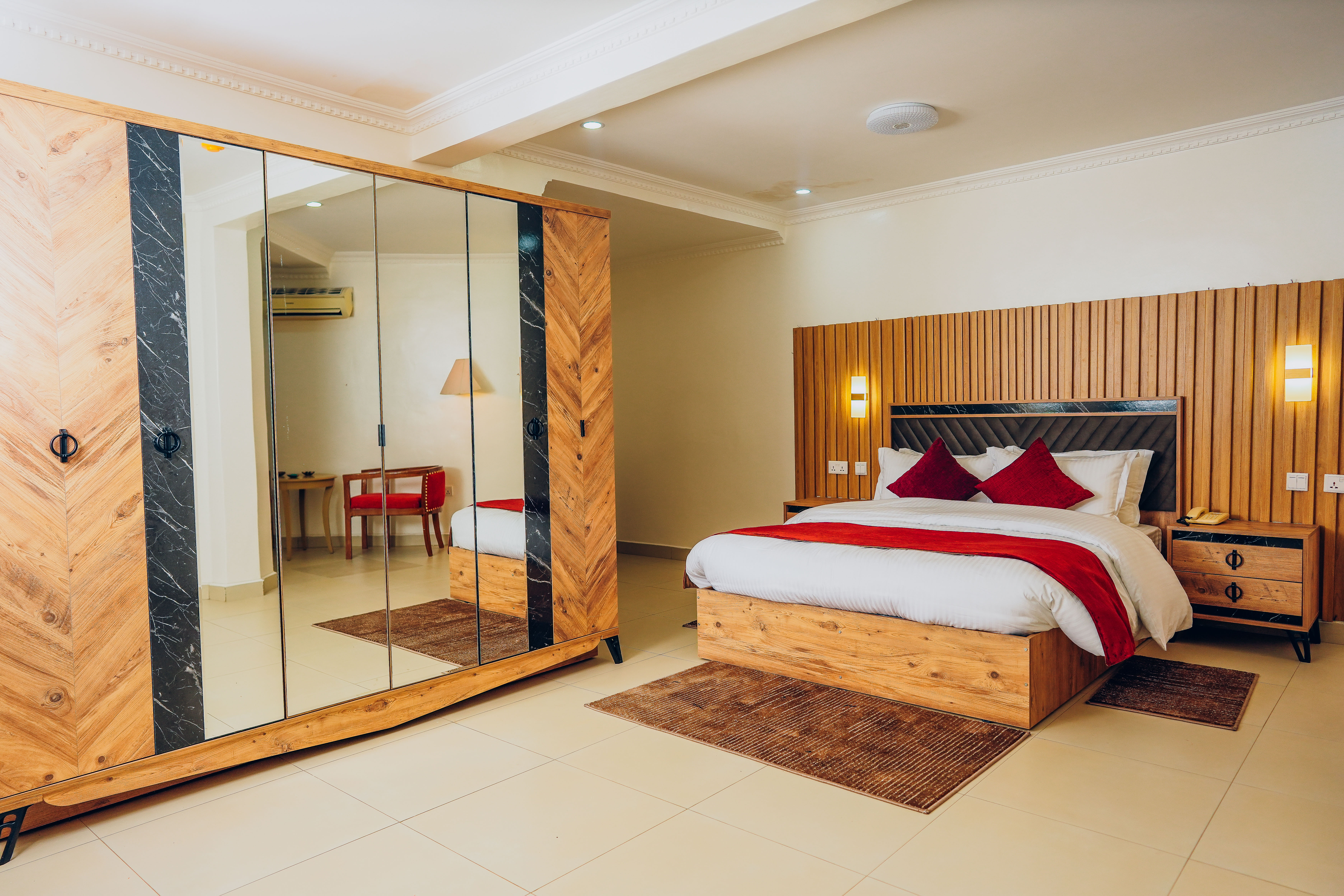 Rakka Hotel - Deluxe room with luxurious red interior and elegant design in Kigali