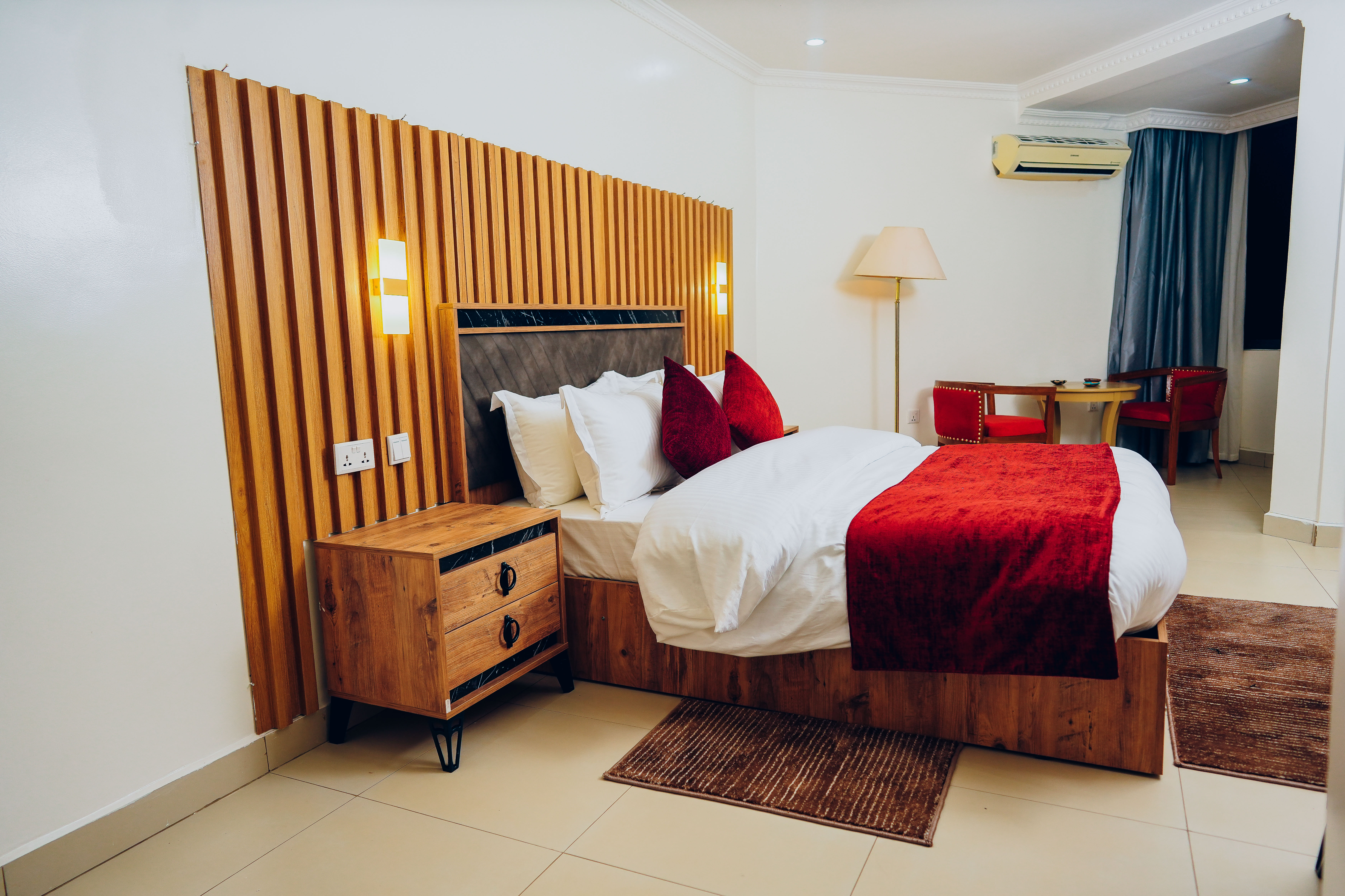 Rakka Hotel - Executive deluxe room featuring contemporary red decor and premium bedding in Kigali