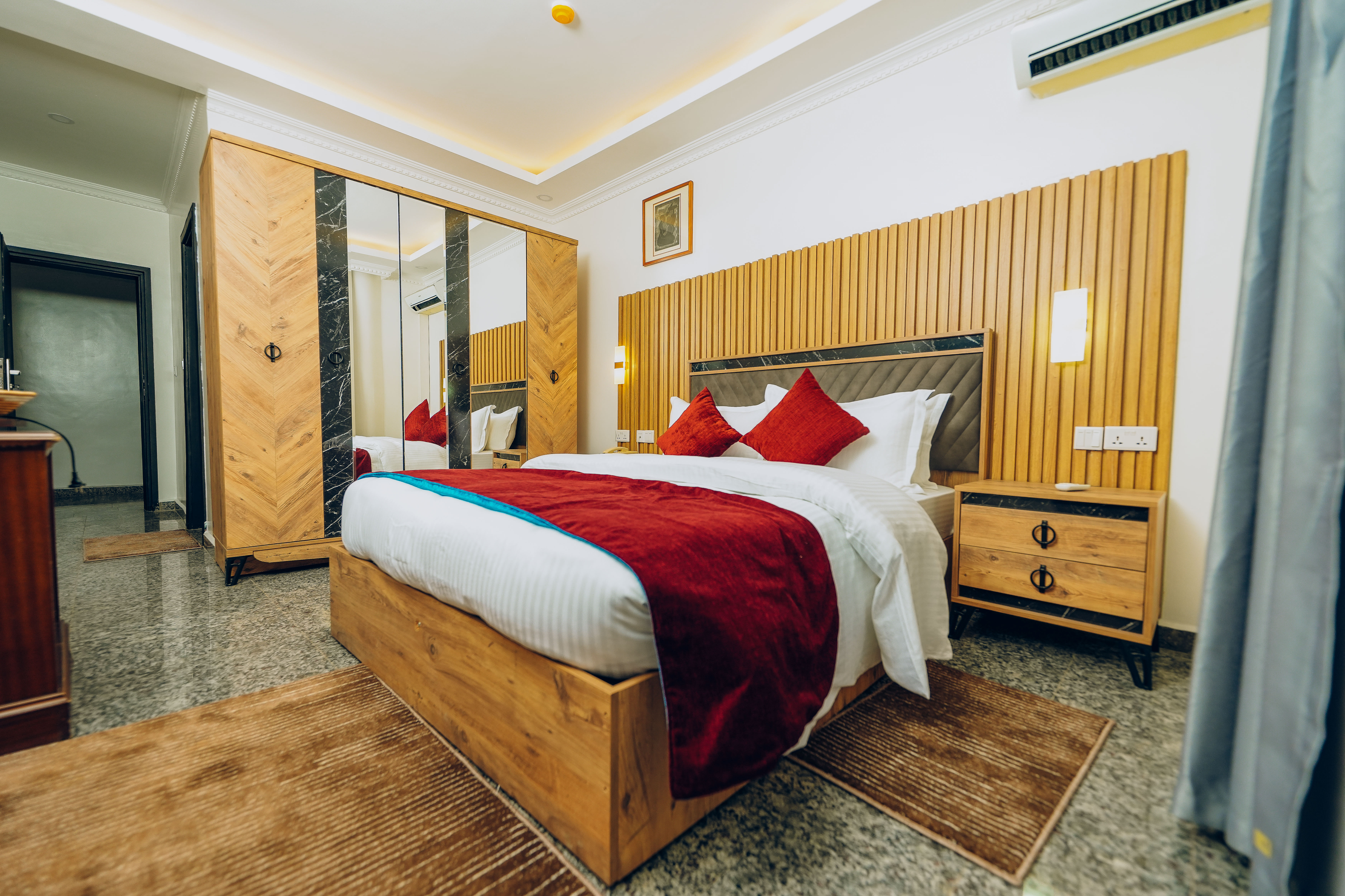 Rakka Hotel - Superior deluxe room with stylish red interior and modern facilities in Kigali